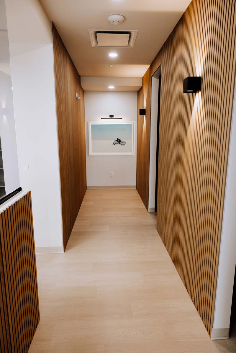 Corridor at Hammons Family Dental Georgetown, lined with vertical oak slat wall panelling