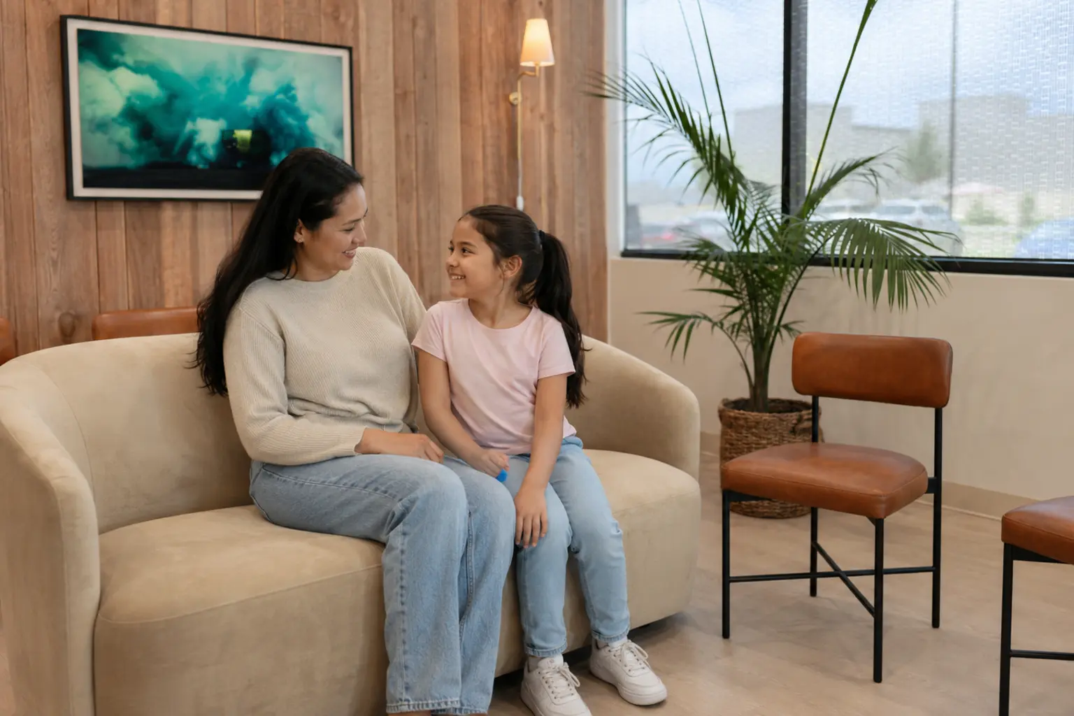 Parent and child in a bright dental waiting area &mdash; general and family dentistry