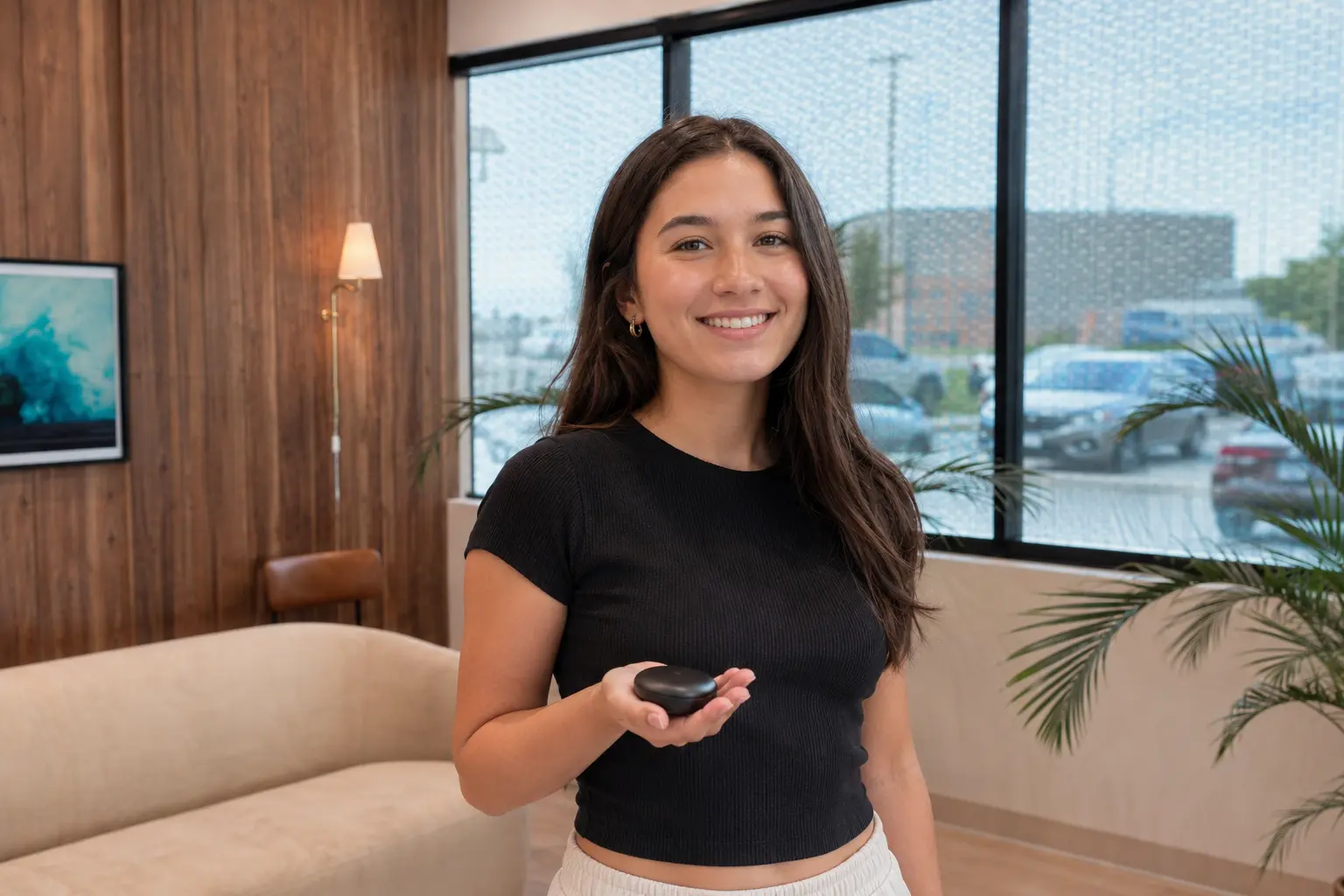 Student holding a clear-aligner case by a bright window